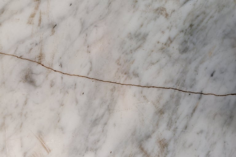 Professional marble crack repair — white marble surface with crack being restored by Refresh Countertops