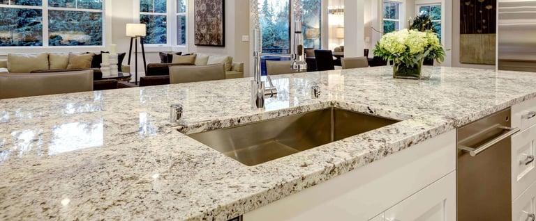 Professional countertop protection — luxury modern kitchen with sealed granite countertops, undermount sink, and stainless steel appliances